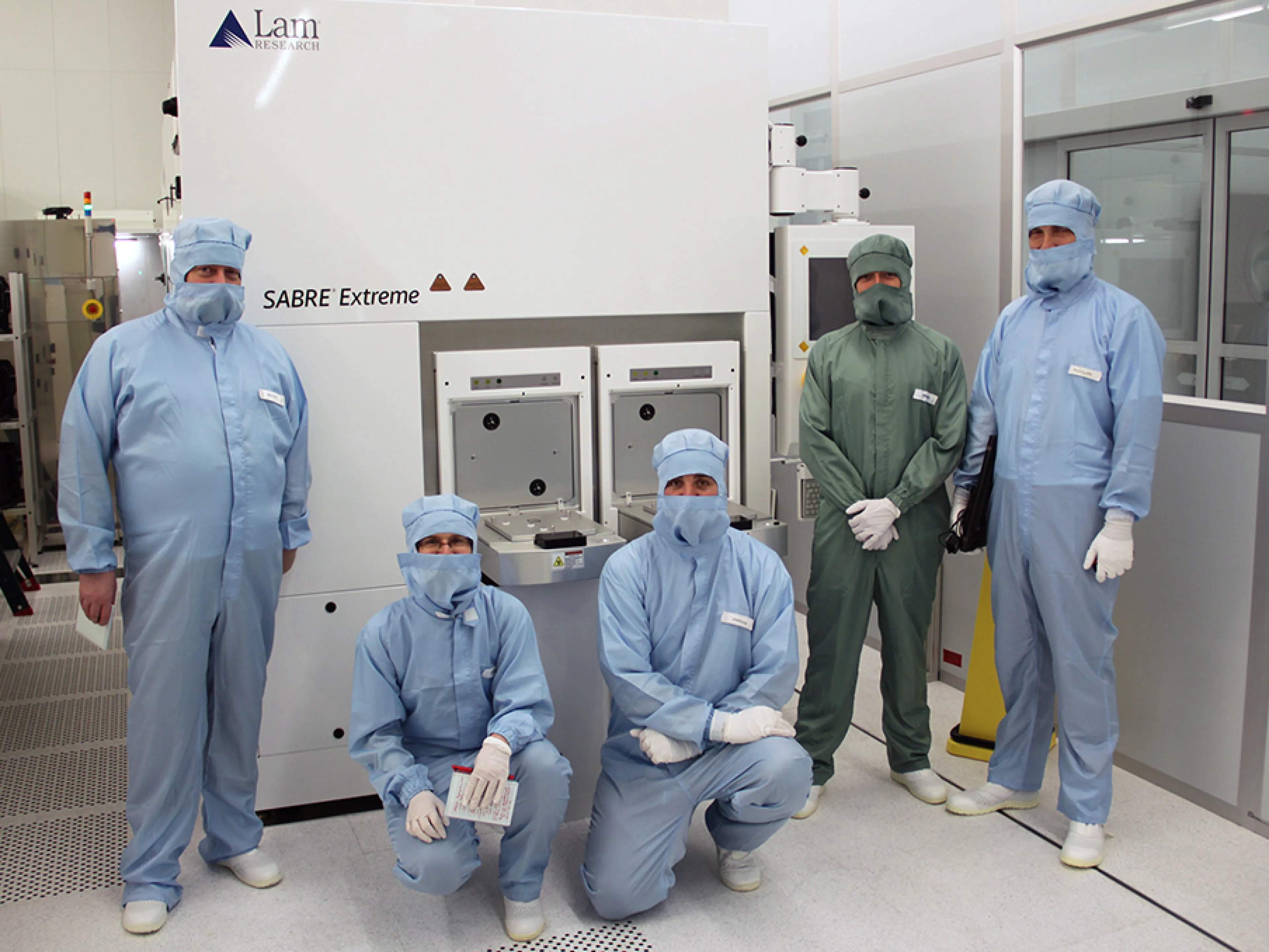 Die Kooperationspartner des BASF und Fraunhofer IPMS vor der Prozessanlage „LAM Sabre Extreme“
